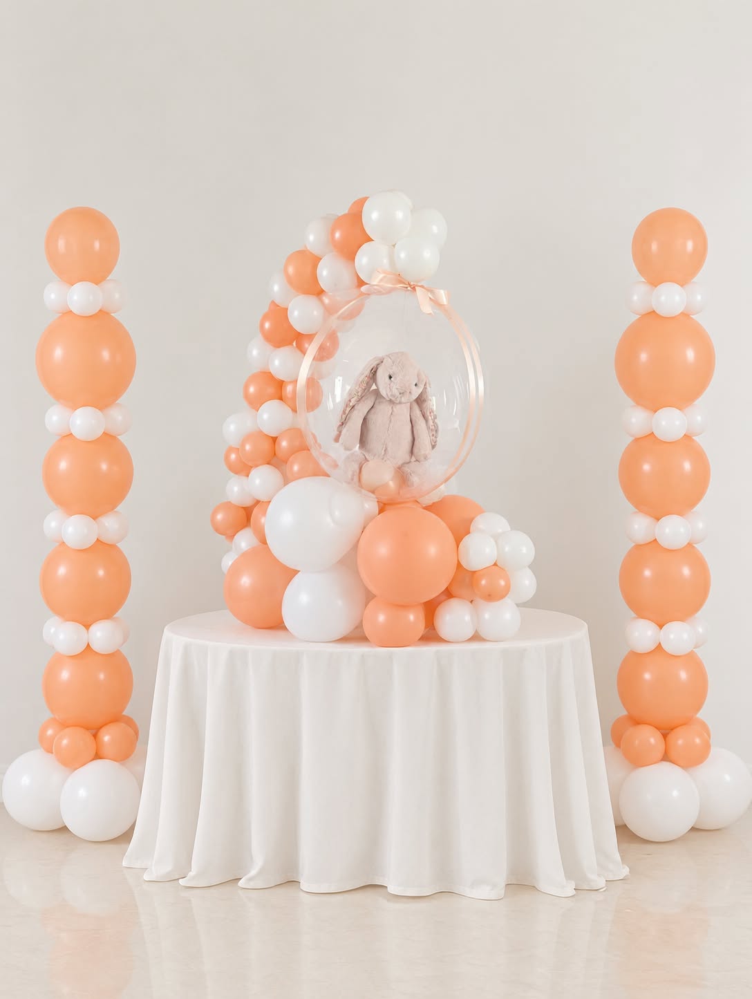Air & Glow peach and white birthday balloon columns with bunny bubble balloon